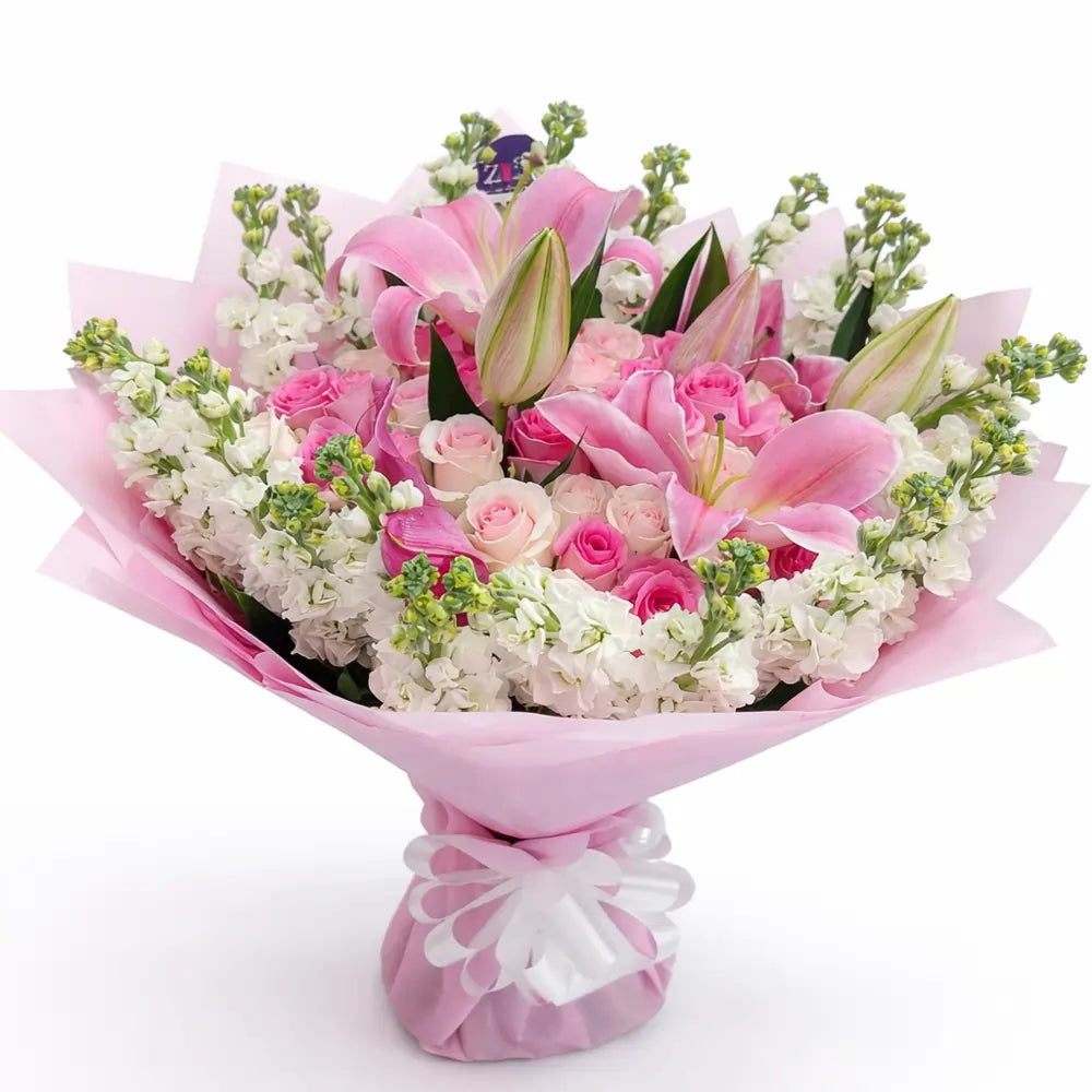 Bouquet of pink Lilies and Roses and white mathiola with a decorative bow on a white background