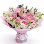 Bouquet of pink Lilies and Roses and white mathiola with a decorative bow on a white background
