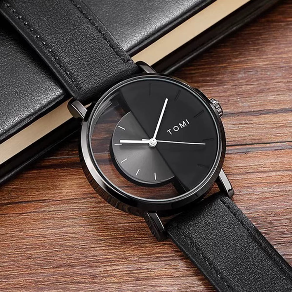 Black wristwatch with leather strap on a wooden surface