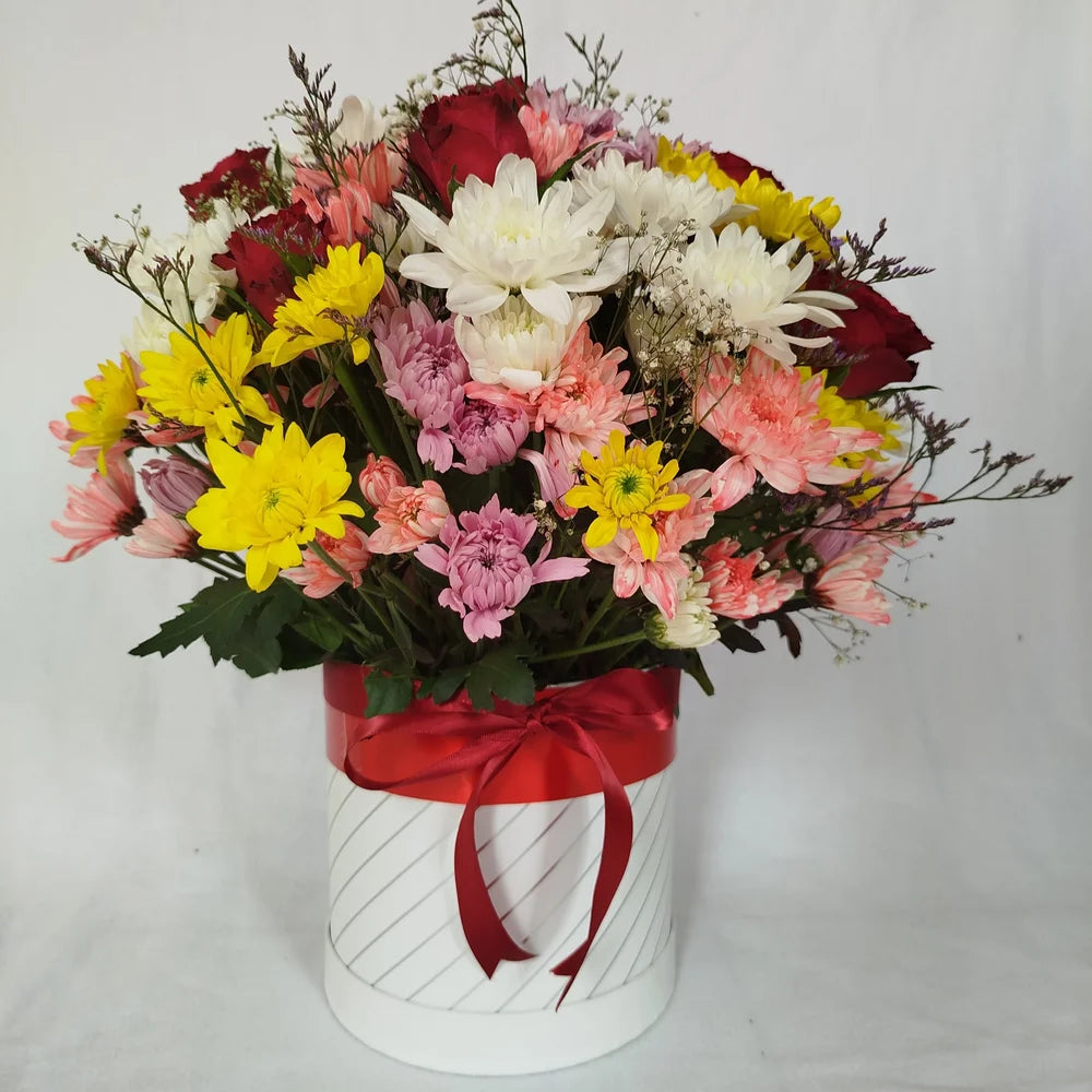 Eternal Embrace flower box featuring mixed flowers in a luxury round box, arranged by Zuri Blooms