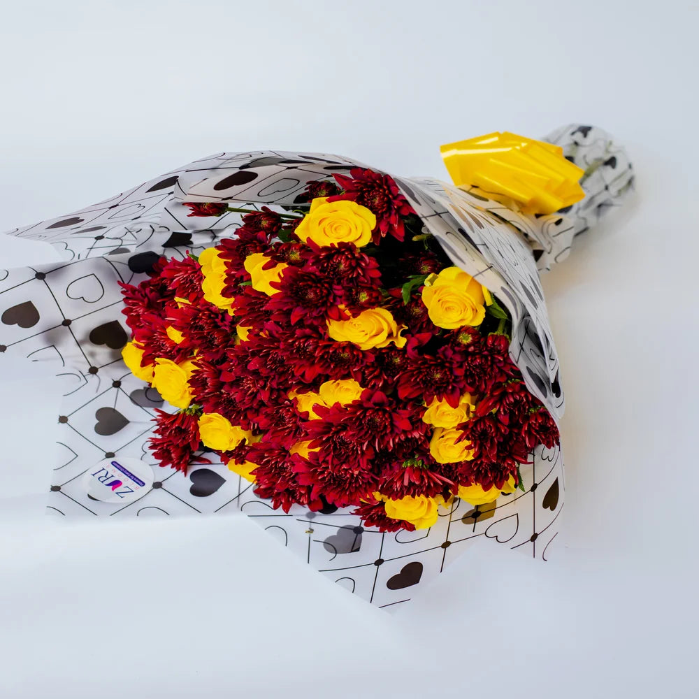 Fiery Sunbeam bouquet featuring yellow roses and red chrysanthemums, arranged by Zuri Blooms