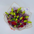 Glamorous Ensemble bouquet featuring red roses, lilies, and purple limonium front, arranged by Zuri Blooms