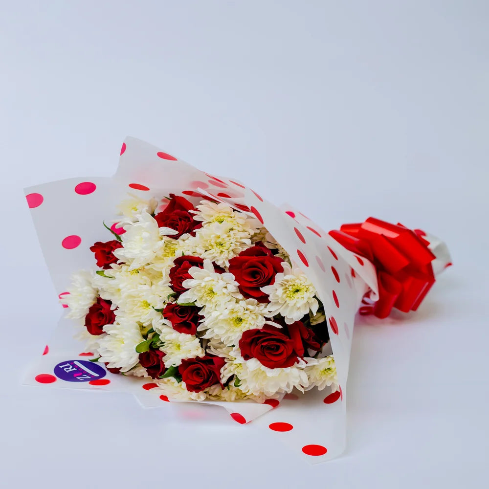 Passionate Purity bouquet featuring red roses and white mums, arranged by Zuri Blooms