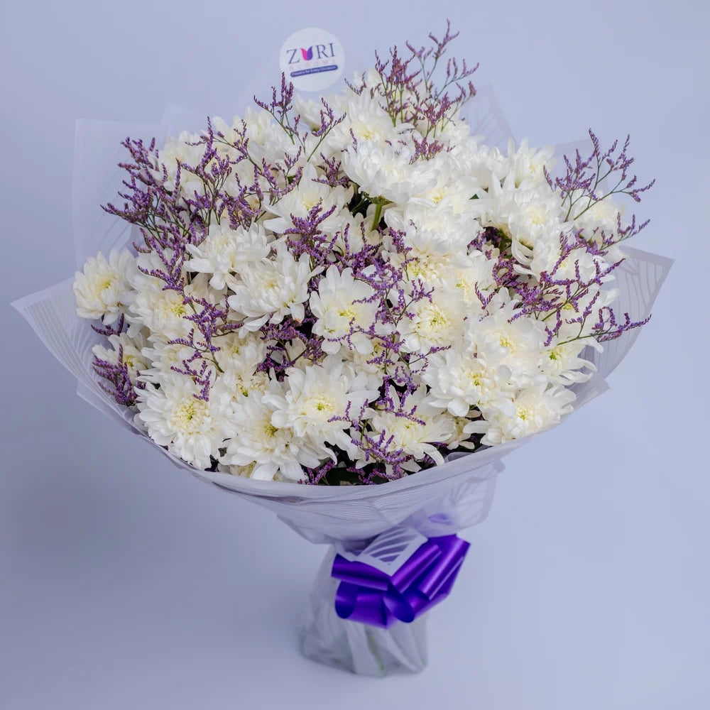 Pure Bliss Medley bouquet featuring white chrysanthemums and purple limonium, top, arranged by Zuri Blooms
