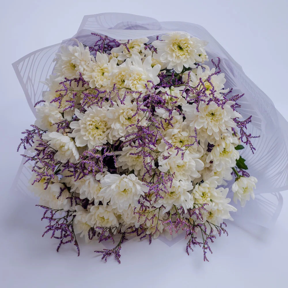 Pure Bliss Medley bouquet featuring white chrysanthemums and purple limonium, front, arranged by Zuri Blooms