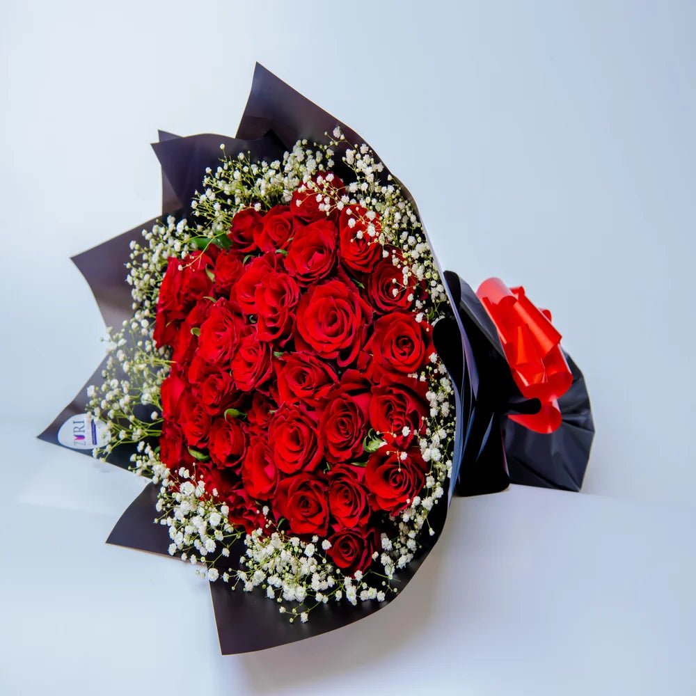 Romantic Rendezvous bouquet featuring red roses and white gypsophila side, arranged by Zuri Blooms