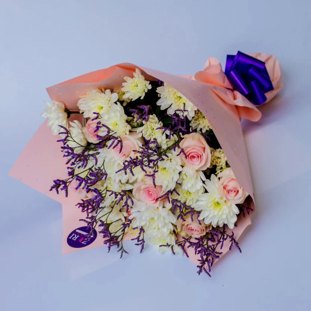 Serene Elegance bouquet featuring pink roses, white chrysanthemums, and purple limonium, arranged by Zuri Blooms