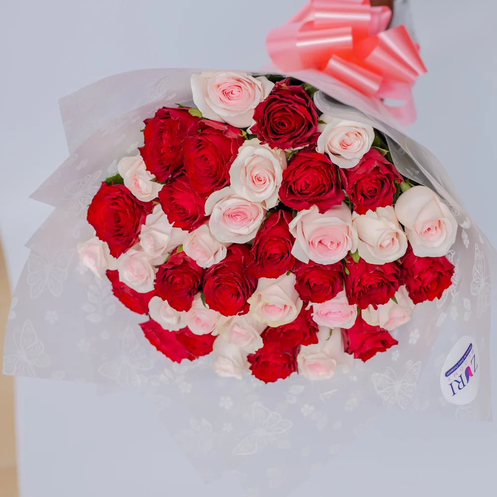 Sweetheart Symphony bouquet featuring red and baby pink roses Classic, arranged by Zuri Blooms
