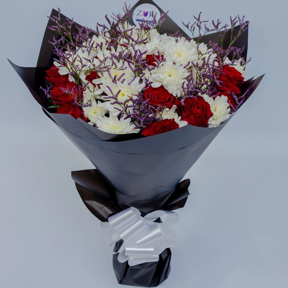 Timeless Elegance bouquet featuring red roses, white chrysanthemums, and purple limonium top, arranged by Zuri Blooms
