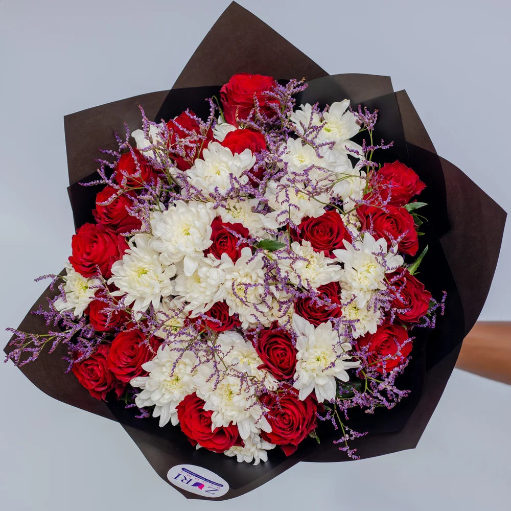 Timeless Elegance bouquet featuring red roses, white chrysanthemums, and purple limonium front, arranged by Zuri Blooms