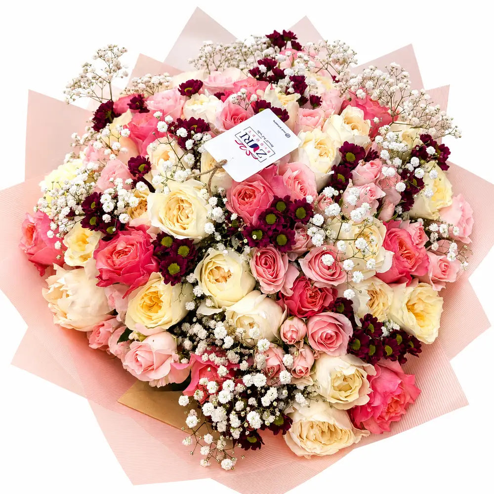 Sweet Elegance bouquet with white, light yellow, pink, and baby pink garden scented roses, purple santini, and gypsophila arranged by Zuri Blooms Nairobi