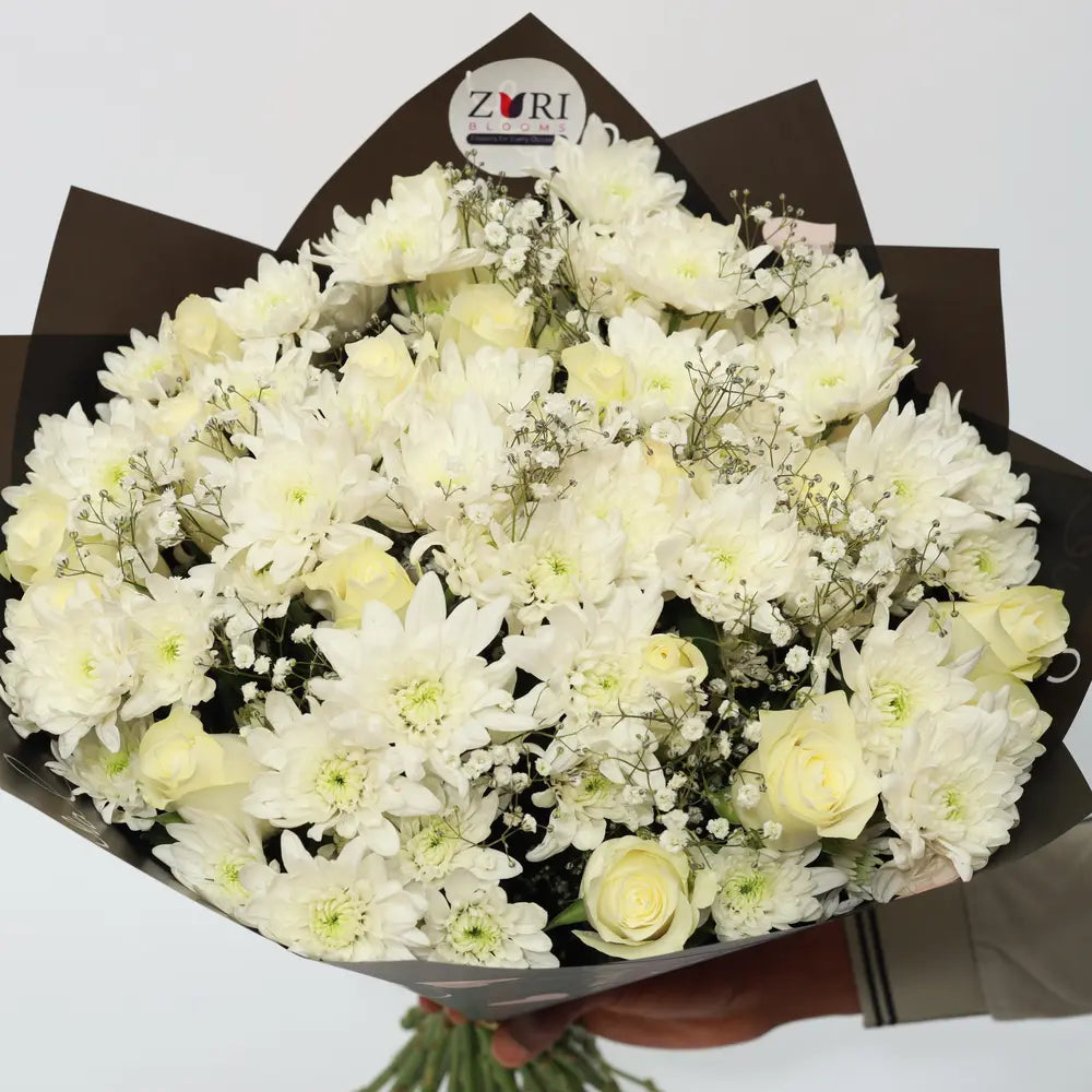 White Ensemble bouquet with white roses, white chrysanthemums, and gypsophila arranged by Zuri Blooms Nairobi